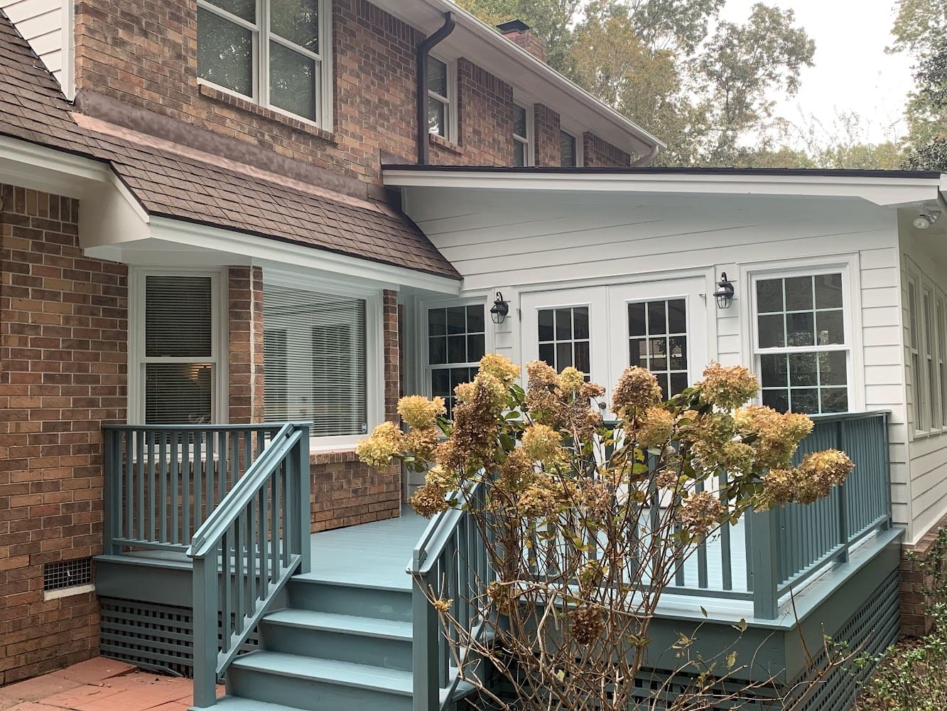 A house with a porch and steps leading to the front door.