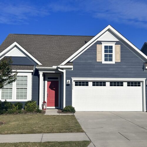 exterior-house-painting-charleston Professionally painted navy blue hardie sided home with white trim boards