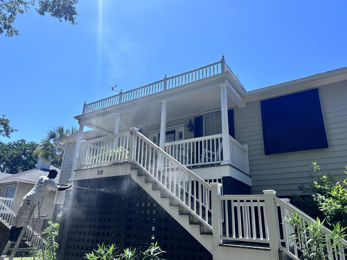 A house with stairs going up to the top of it.